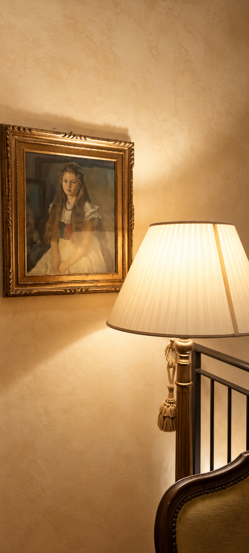 Period portrait in a gilded frame lit by a lamp inside Villa Sant'Erasmo
