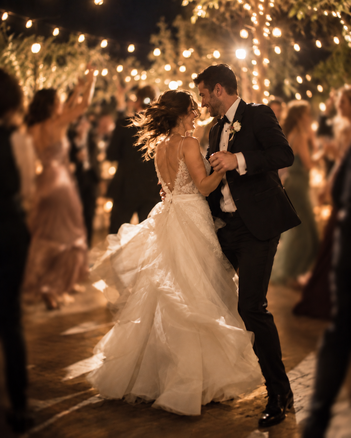 The newlyweds dance wrapped in lights in the garden of Villa Sant'Erasmo