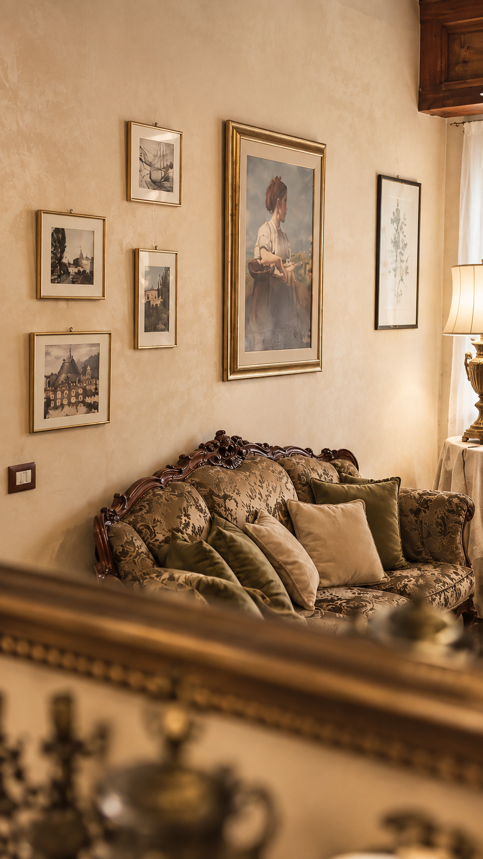 Sitting room at Villa Sant'Erasmo with a period sofa, cushions and paintings on the walls