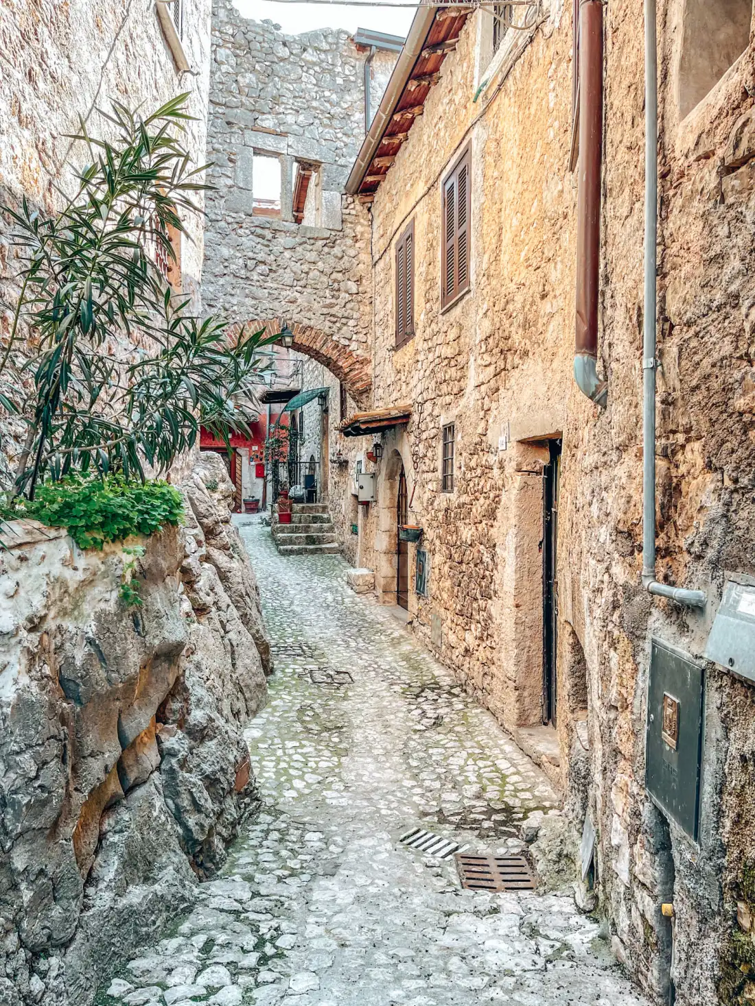 Steep cobbled lane in the medieval village of Fumone with a stone arch