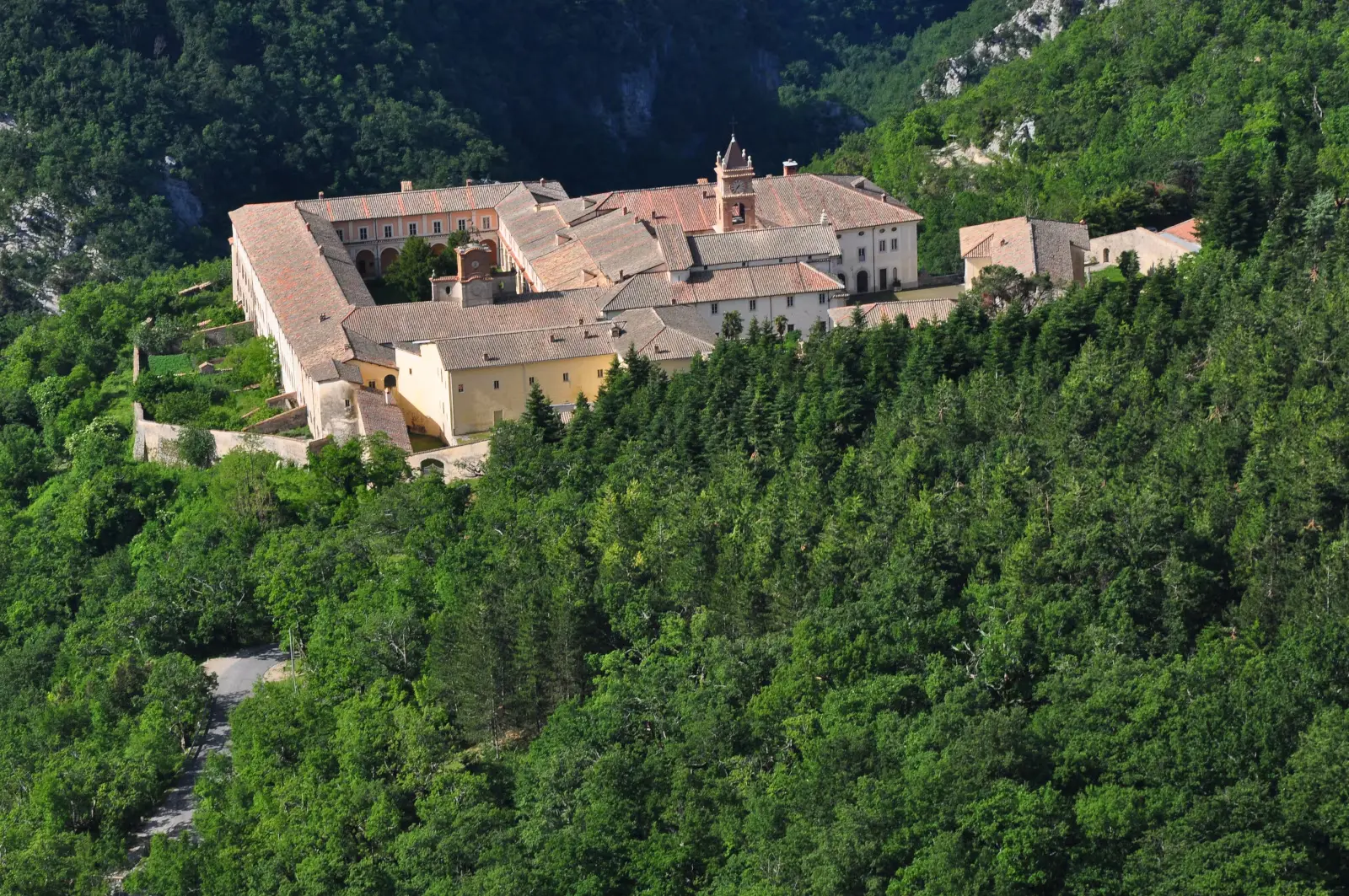 Aerial view of the Certosa di Trisulti nestled in the woods of the Monti Ernici, with its bell tower and terracotta roofs
