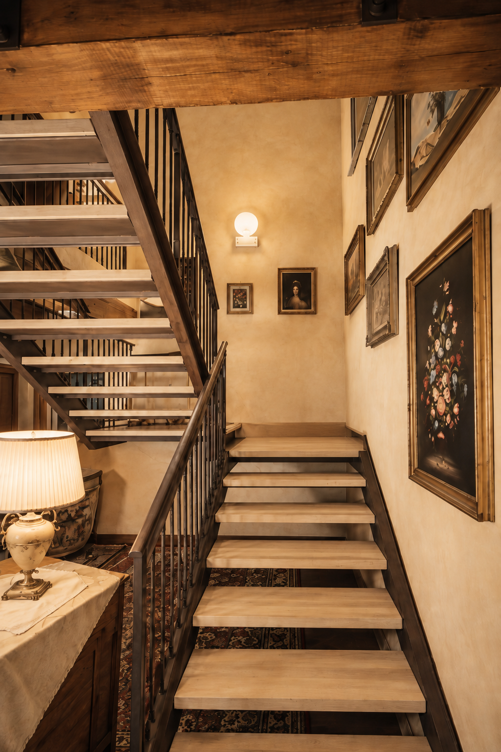 Interior wood and iron staircase with paintings on the walls at Villa Sant'Erasmo