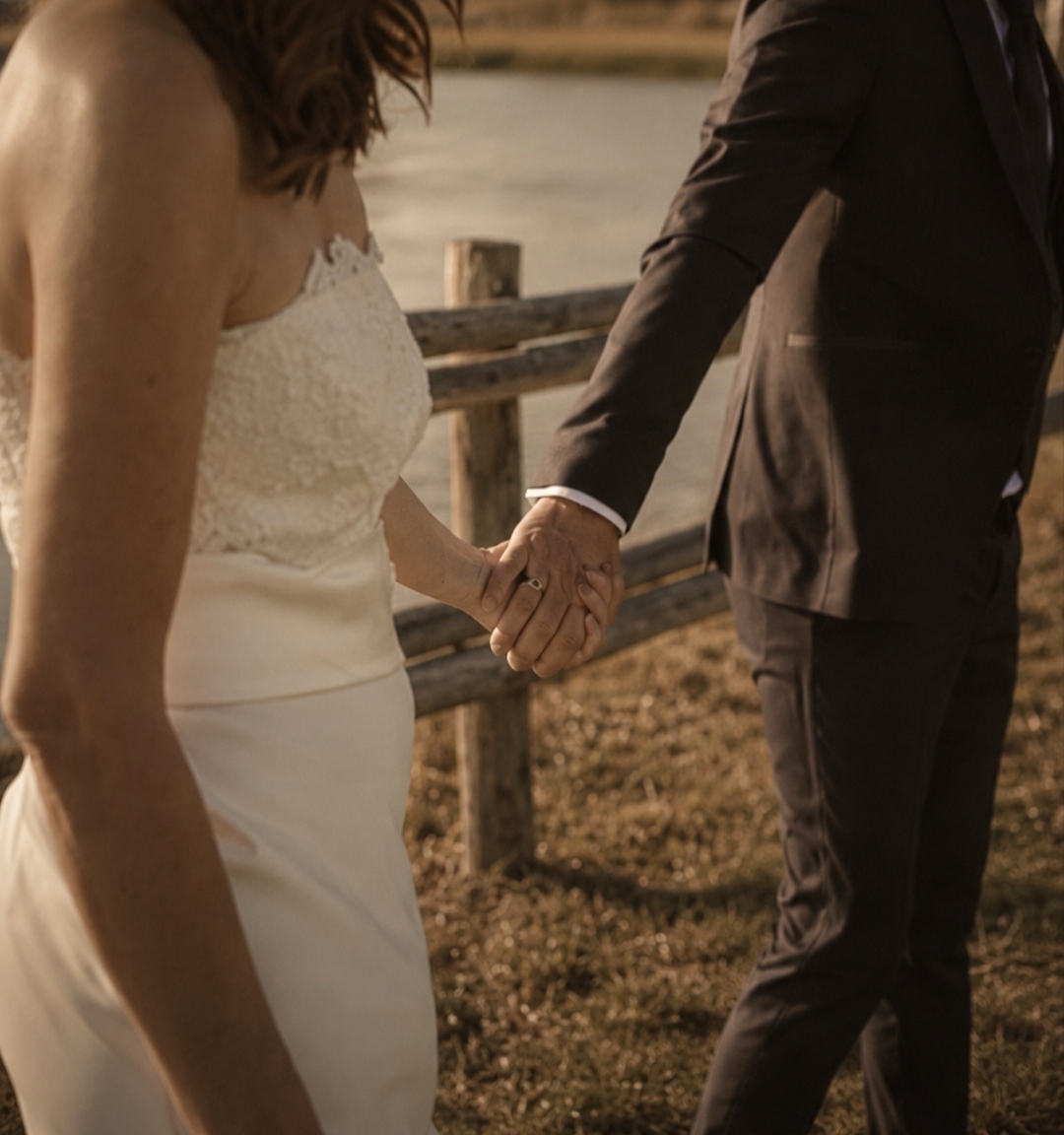 The newlyweds walk hand in hand towards Lake Canterno