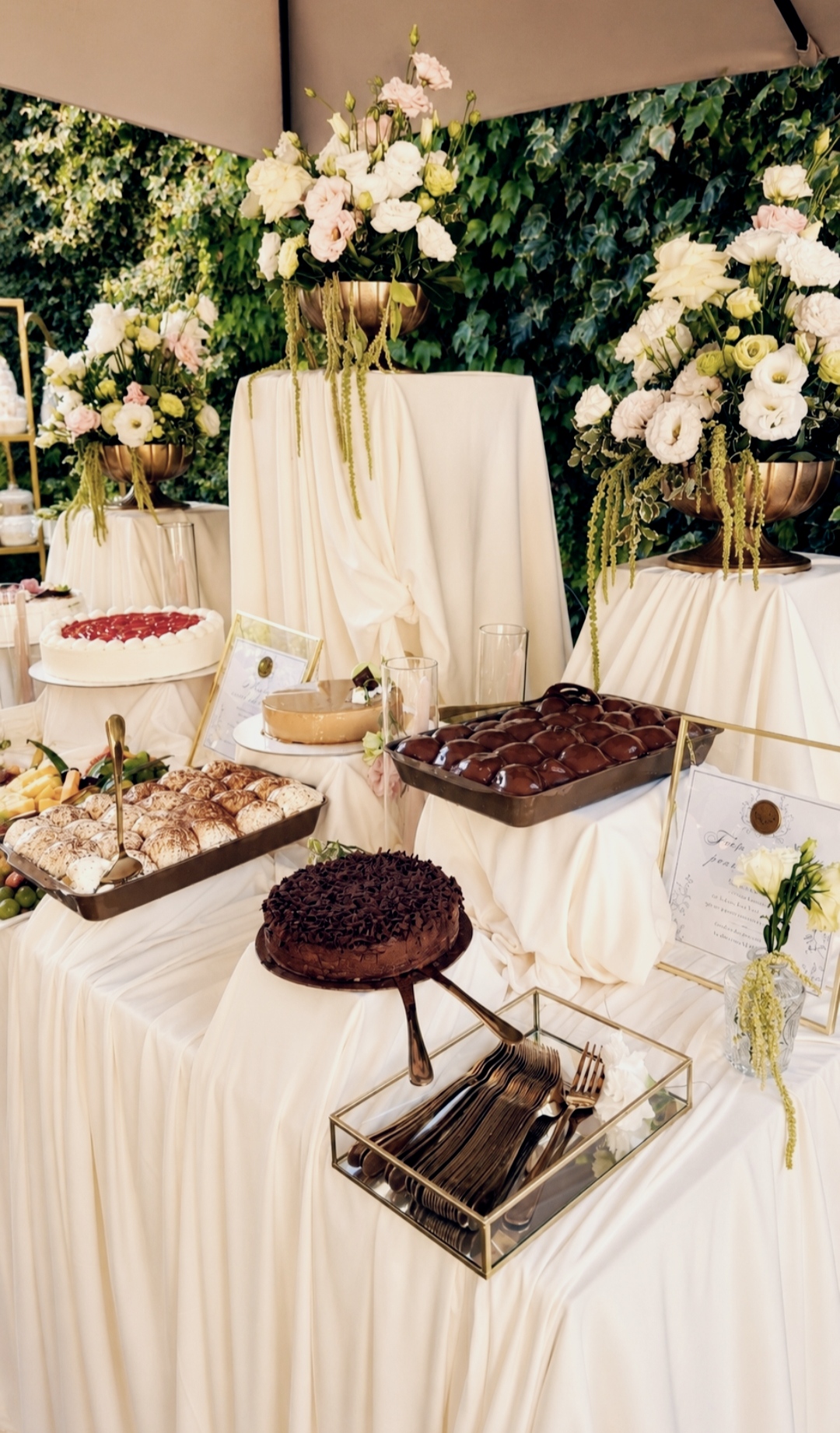 Dessert buffet with cakes and flowers in the garden
