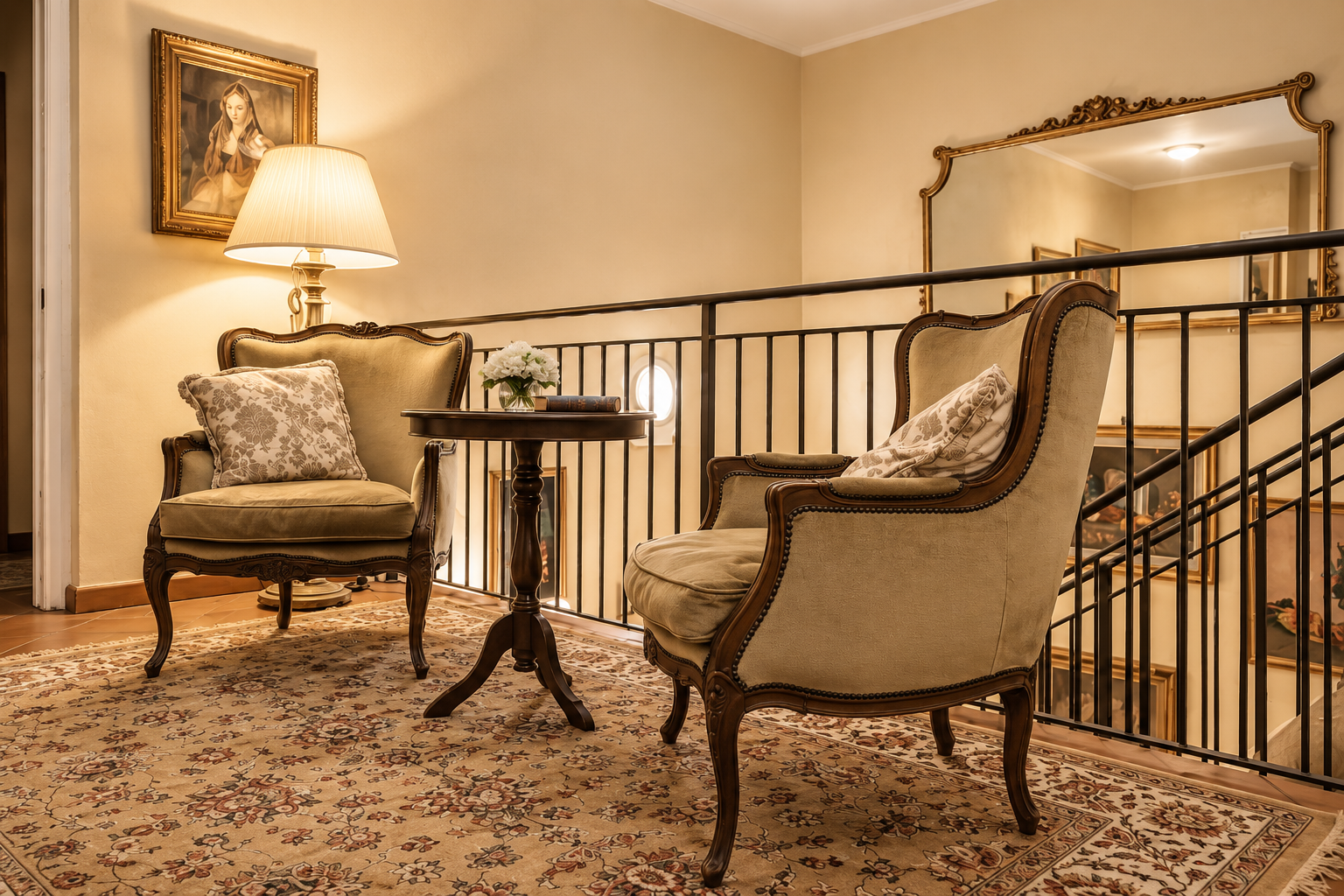Small sitting room upstairs at Villa Sant'Erasmo with period armchairs and a gilded mirror