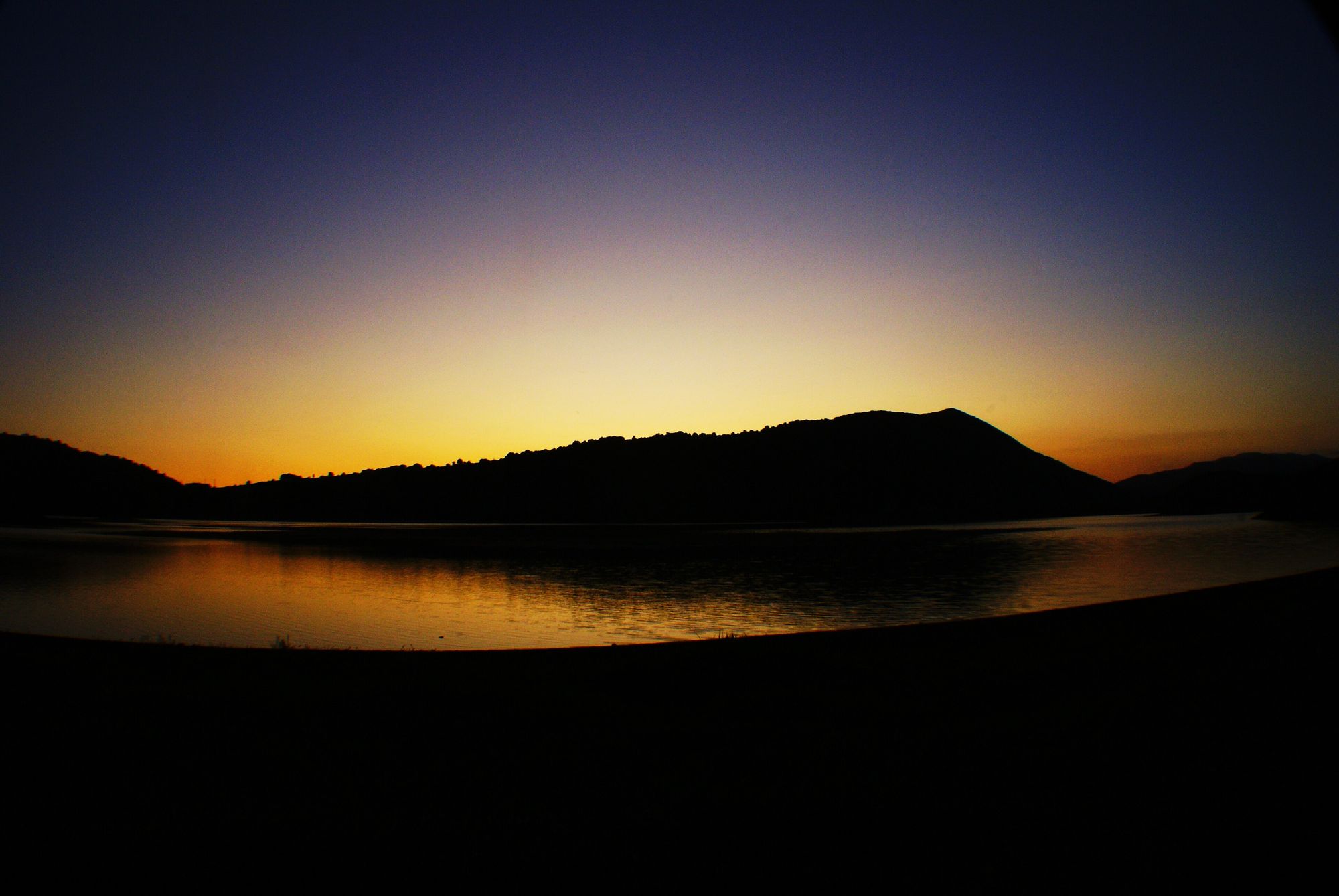 Lago di Canterno ringed by the woods of the Monti Ernici